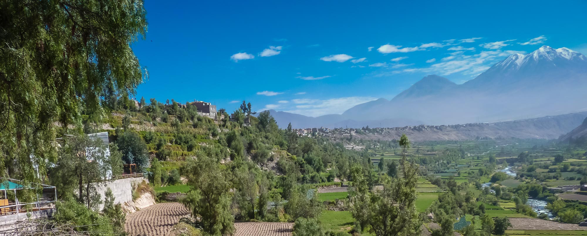Lush green valley and active volcano seen from a private Peru tour to Colca Canyon