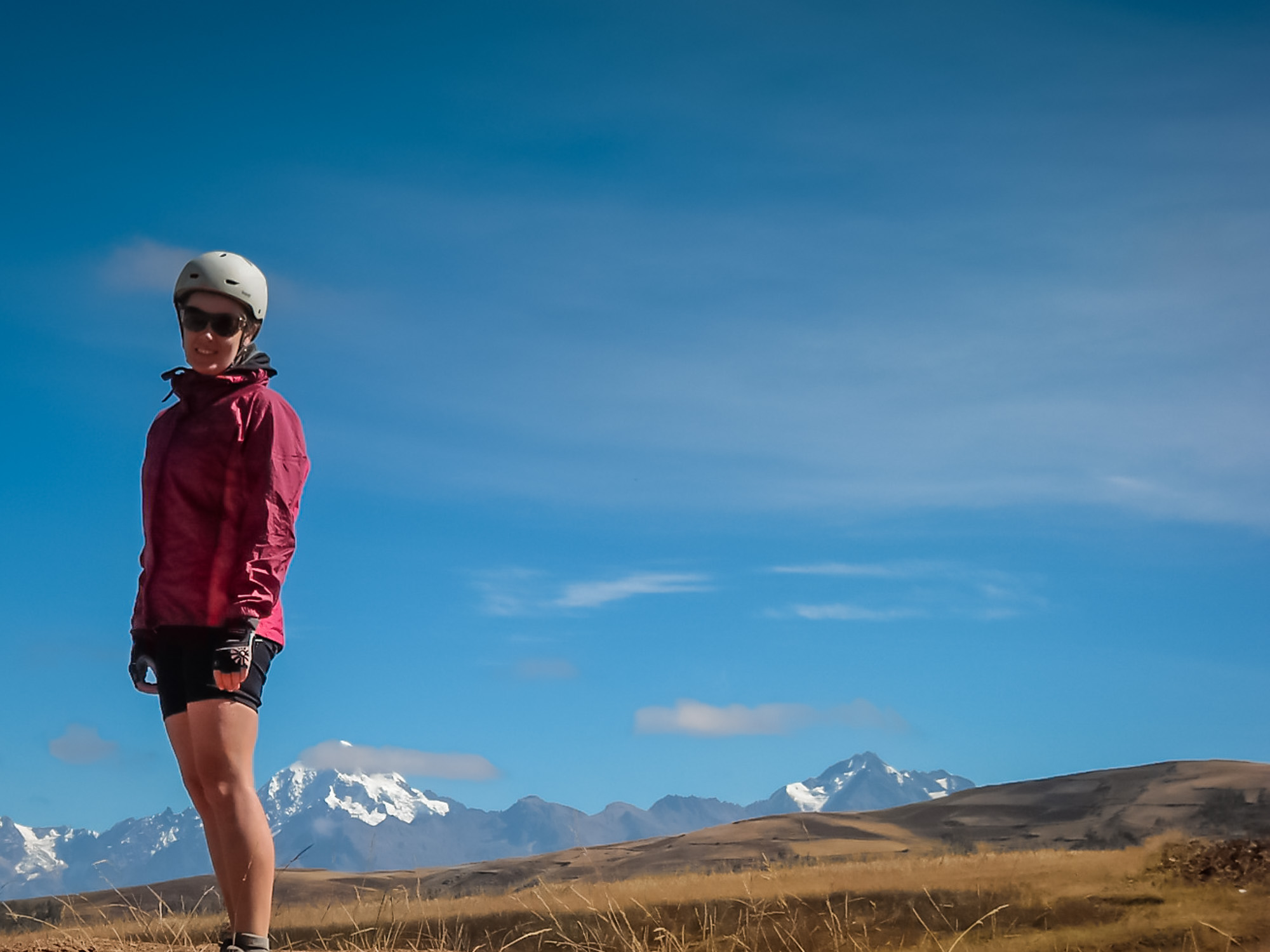 Peru guided tour guest in bike helmet in high mountain scenery
