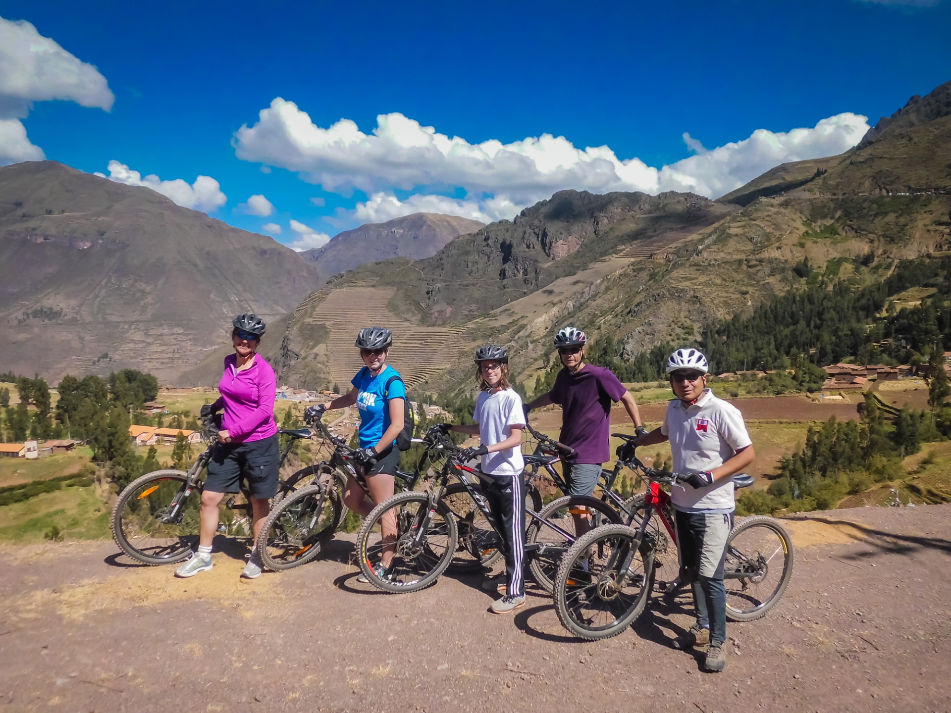 Three women on bikes contemplate mountain biking Peru